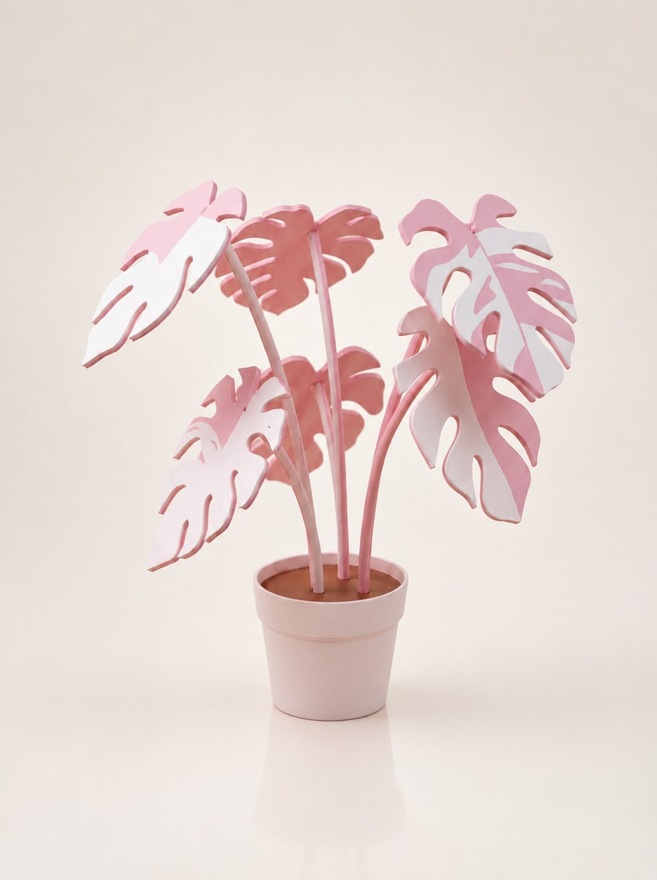 The Leafora sculpture on a table, six pink and white leaves fanned above the planter